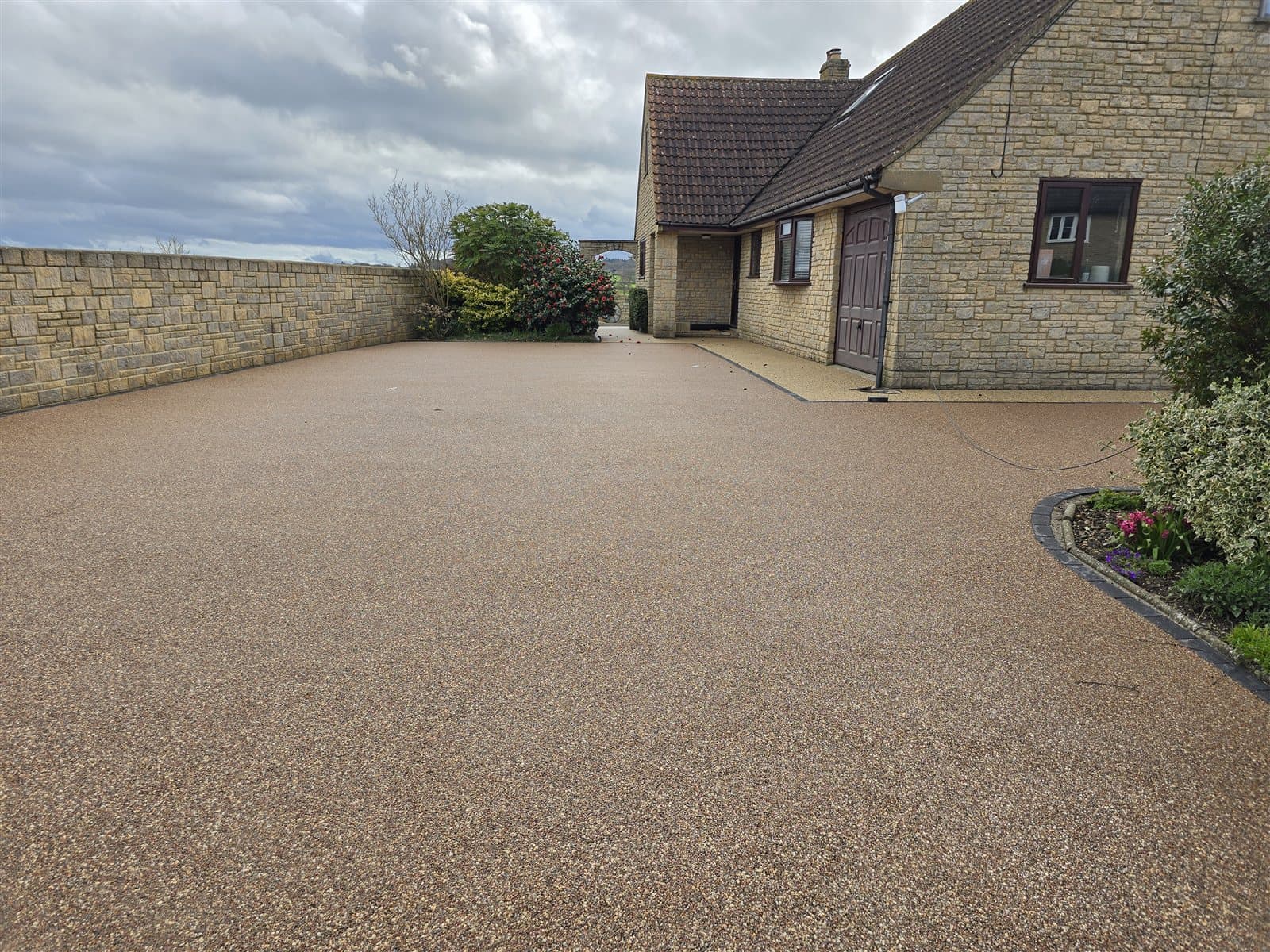 Resin bound driveway with stone edging detail, installed by Quantock Paving