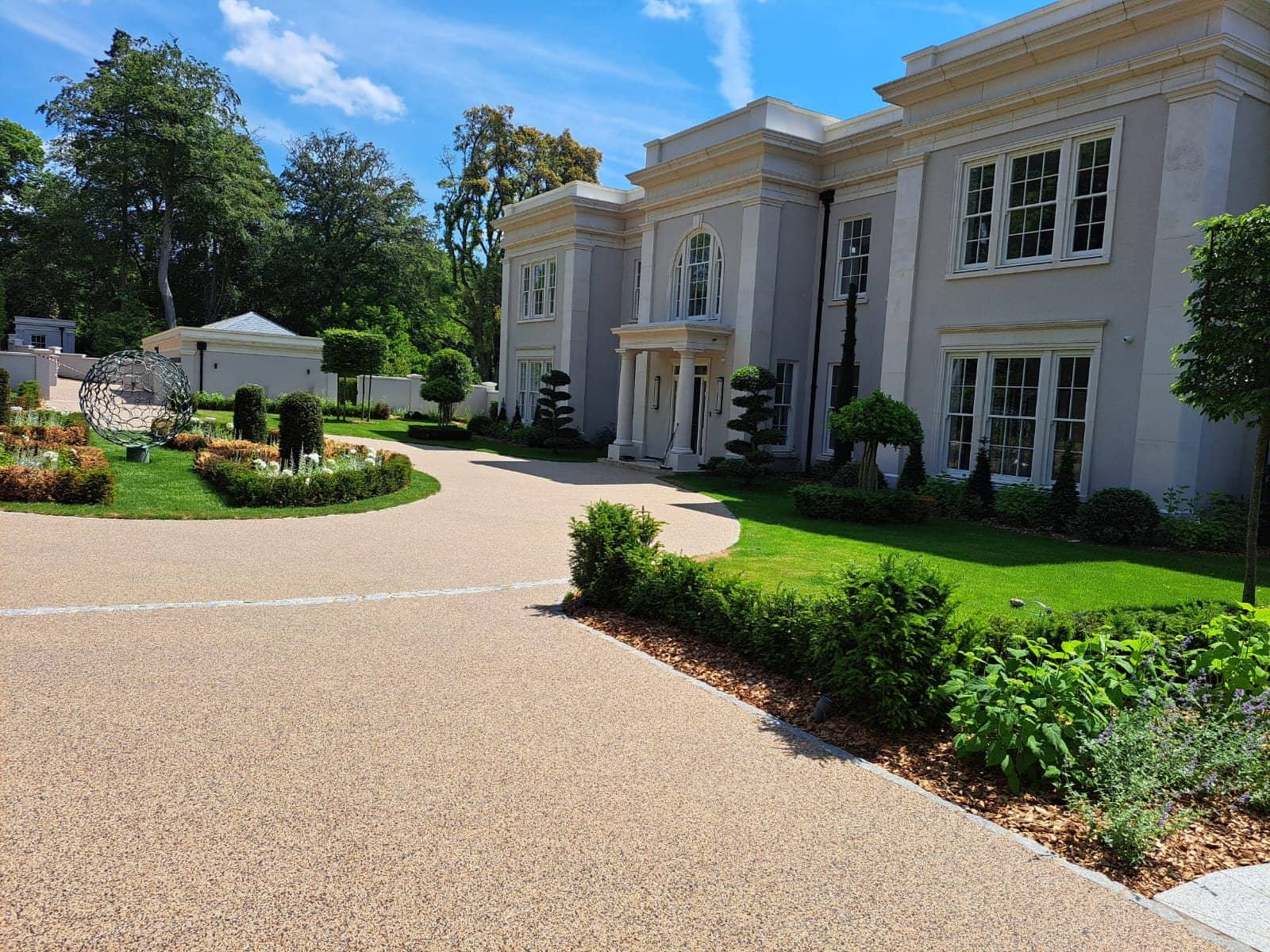 Sweeping golden resin bound driveway installed by Quantock Paving